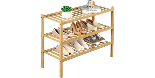 3-tier bamboo shoe rack with six pairs of shoes, a plant, and books on top, space-saving storage